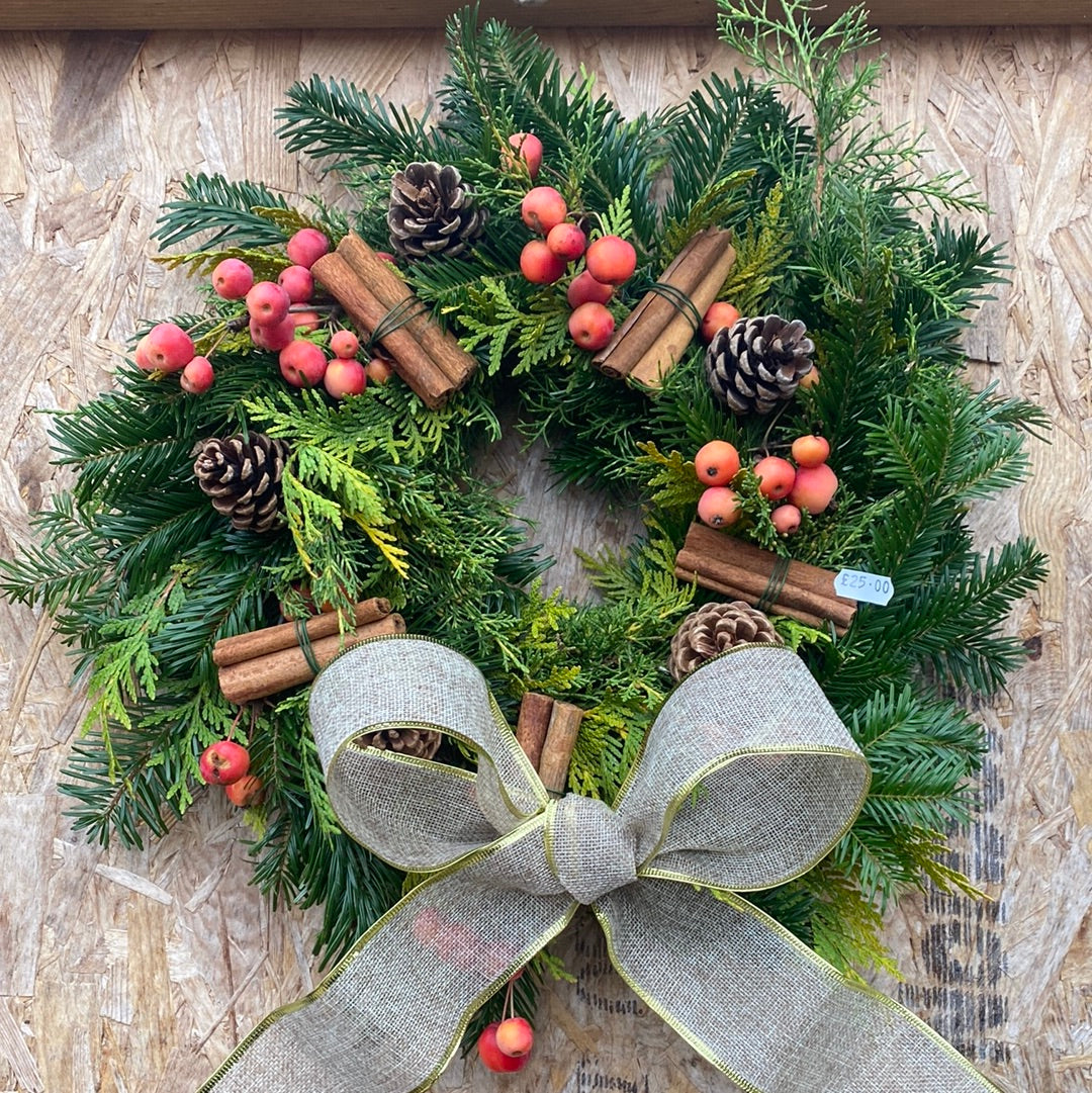 Decorated fir Christmas wreath - crabapples, pine cones, cinnamon and ribbon