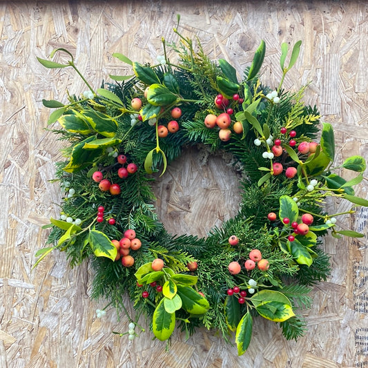 Decorated fir Christmas wreath - holly, crabapples and mistletoe