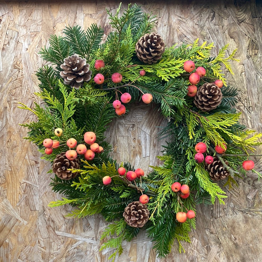 Decorated fir Christmas wreath - pine cones, crabapples